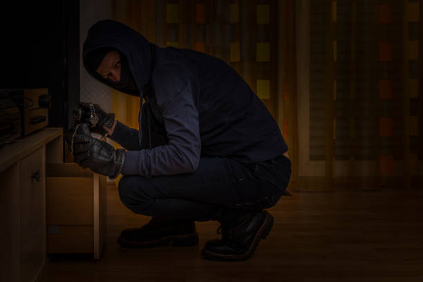 istock burglar indoors searching in drawer 1067829534