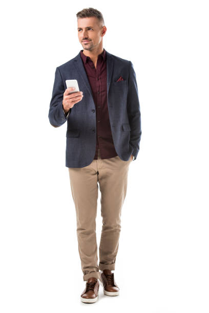 istock stylish man in jacket using smartphone and looking away isolated on white 1067832616