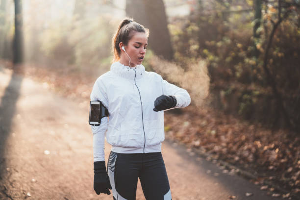 istock Sportswoman checking pulse after sports activity 1067833844