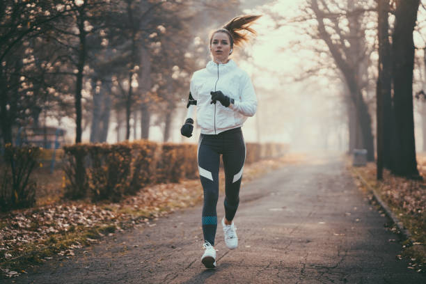 istock Woman jogging during winter morning 1067834212