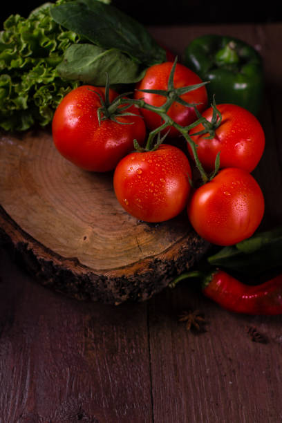 Healthy set of fresh organic vegetables tomatoes, broccoli, cauliflower, corn, chili, pepper on wooden background