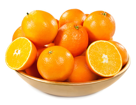 Fresh oranges in a bowl on the white background