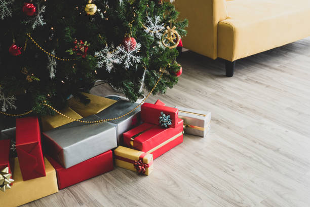 istock Colorful gift boxes under decorated Christmas tree on wooden floor. 1067843072