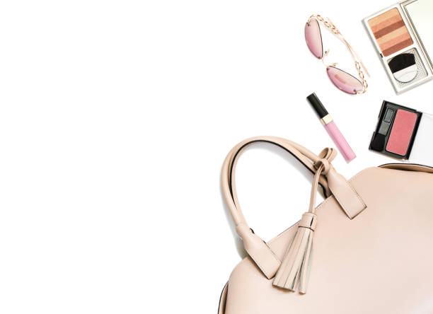 istock Beige woman's handbag and accessories isolated on white background. 1067844672
