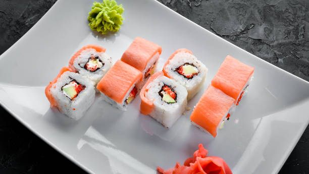 istock Sushi roll with seafood. Top view. On a white wooden background. 1067846978
