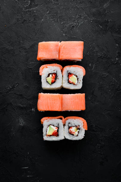 istock Sushi roll with seafood. Top view. On a white wooden background. 1067847046