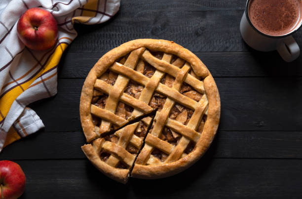 istock Apple pie and slice on a black table. Top view. Savory pastry 1067847924