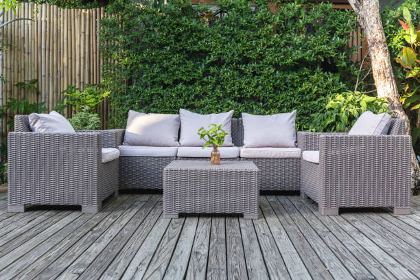 Large terrace patio with rattan garden furniture in the garden on wooden floor. Large terrace patio with rattan garden furniture in the garden on wooden floor armchair photos stock pictures, royalty-free photos & images