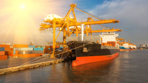 istock Container ship in export and import business and logistics. Shipping cargo to harbor by crane. Water transport International. Aerial view and top view. 1067851192