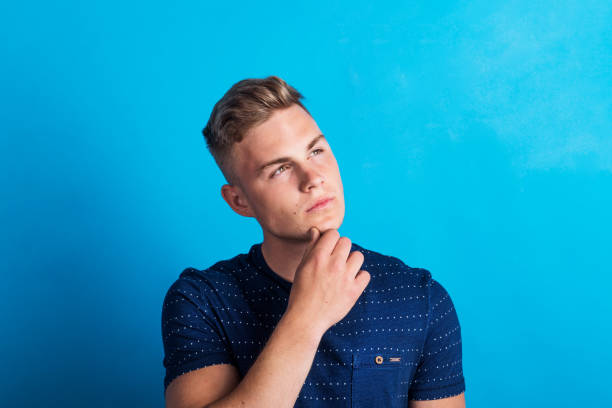 istock Portrait of a serious thoughtful young man in a studio standing in a studio. 1067851556