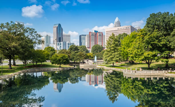 Charlotte, NC Skyline from Marshall Park The Skyline of Charlotte is reflecting on the Water in Marshall Park reflection lake stock pictures, royalty-free photos & images