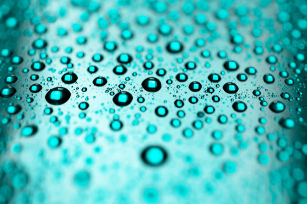 istock Refreshing drops of water on blue background 1067857300