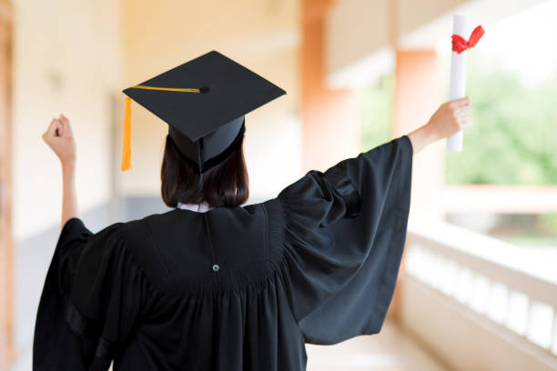 istock Black graduates wear black suits on graduation day at university. 1067857520