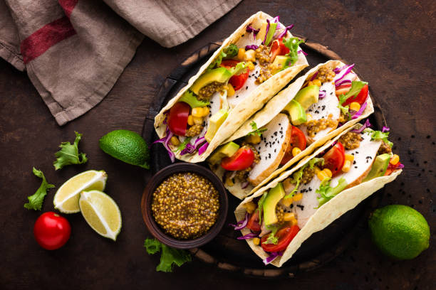 istock Mexican tacos with chicken meat, vegetables and fresh greens 1067862032