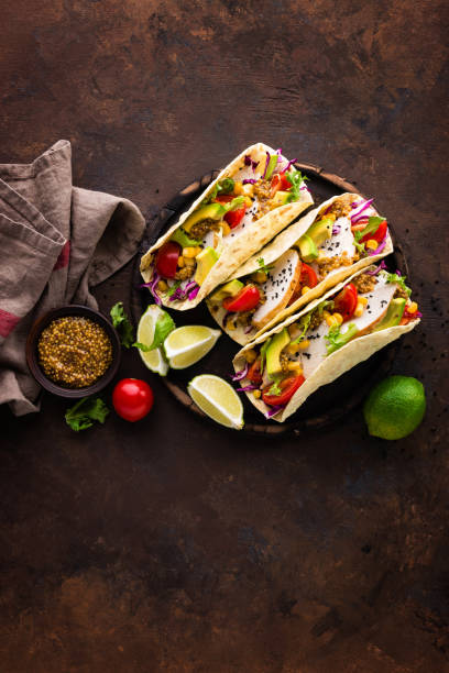 istock Mexican tacos with chicken meat, vegetables and fresh greens 1067863238