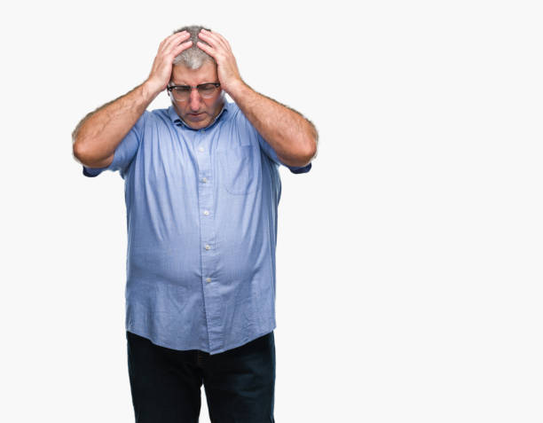 istock Handsome senior man wearing glasses over isolated background suffering from headache desperate and stressed because pain and migraine. Hands on head. 1067864274