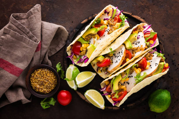 istock Mexican tacos with chicken meat, vegetables and fresh greens 1067864292