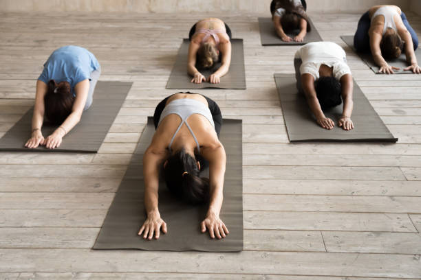 istock Group of people practicing yoga lesson, doing Child exercise, Balasana 1067864388