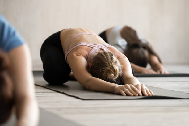 istock Group of people practicing yoga, doing Child pose, close up 1067864398