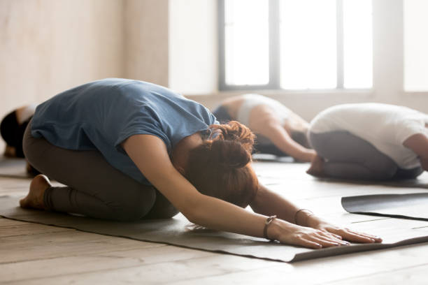 istock Group of people practicing yoga, doing Child pose, close up 1067864646