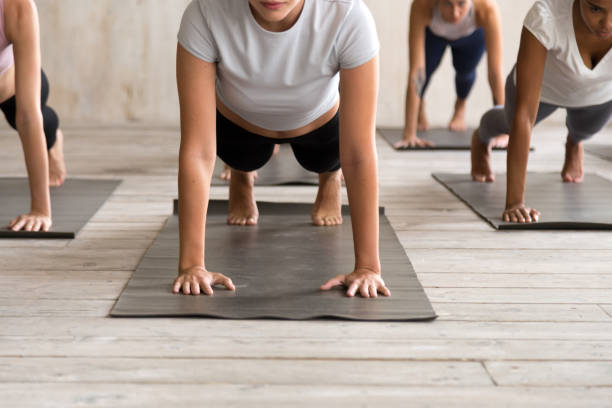 istock Group of people practicing yoga, Plank pose close up 1067864652