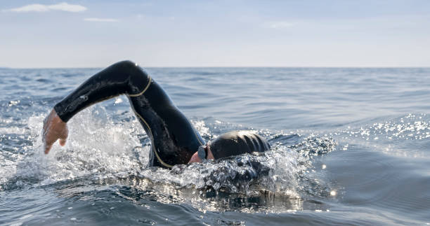 istock Open water swimmer swimming in sea 1067877374