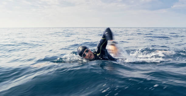 istock Open water swimmer swimming in sea 1067877436