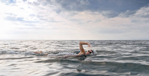 istock Female swimmer swimming forward crawl in sea 1067877446