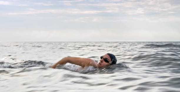 istock Female swimmer swimming forward crawl in sea 1067877452