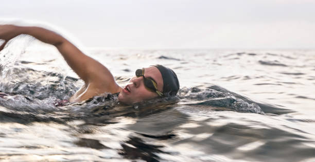 istock Female swimmer swimming forward crawl in sea 1067877456