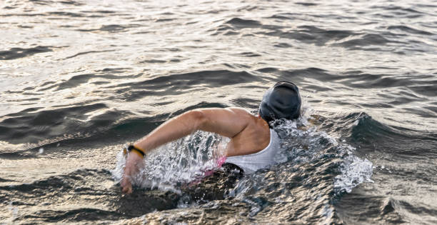 istock Female swimmer swimming forward crawl in sea 1067877482