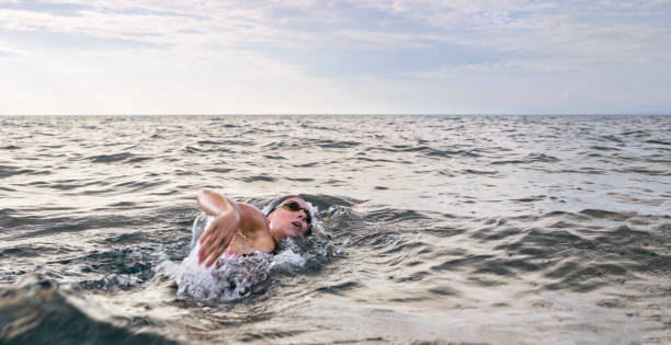 istock Female swimmer swimming forward crawl in sea 1067877486