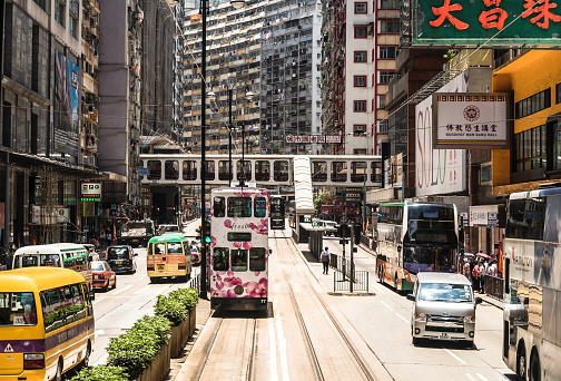 Hong Kong, China - May 16 2018: Tram and other traffic in the streets of North Point, a high density mostly working class residential district in Hong Kong island, China