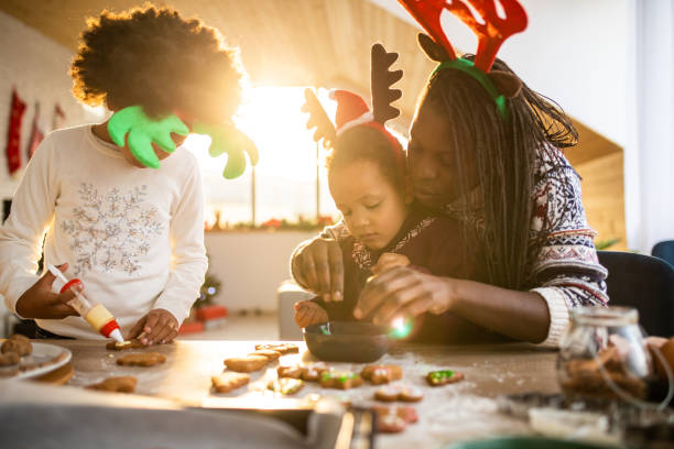 istock Mom and daughters decorating cookies 1067879434