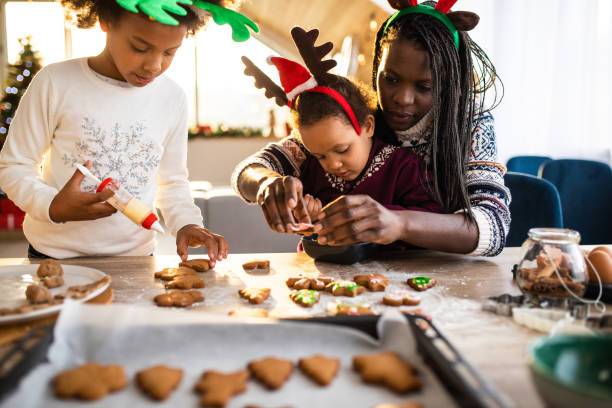 istock Mom and daughters decorating cookies 1067879440