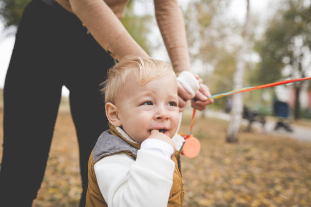 istock Cute blond toddler in the park with mom 1067881150