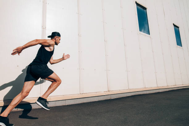 istock Sporty man runner running in city sreet 1067889194