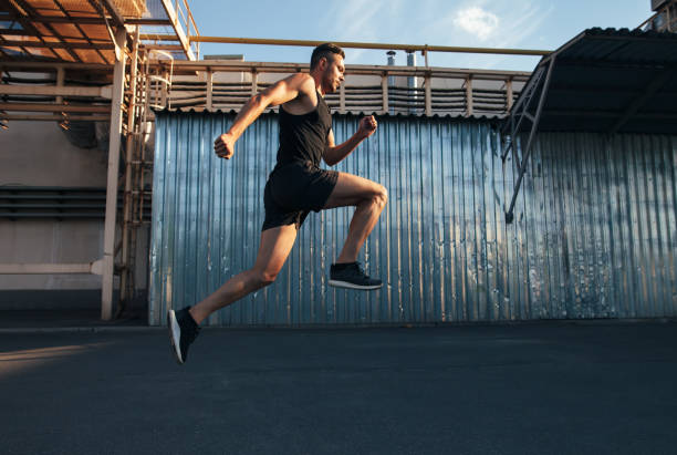 istock Handsome young man running in ndustrial building background 1067889202
