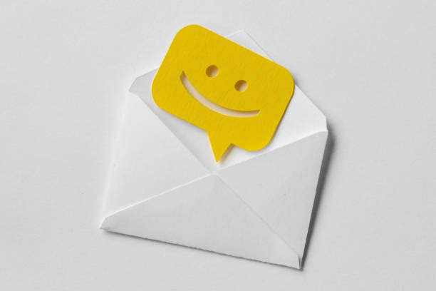 Email envelope with smiling message bubble on white background Email envelope with smiling message bubble on white background sending photos stock pictures, royalty-free photos & images