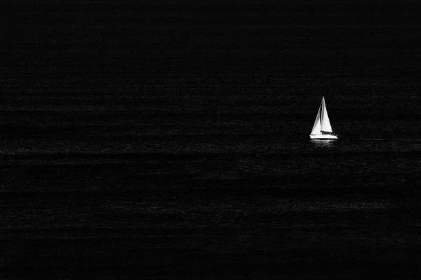 sailboat on the sea in black and white