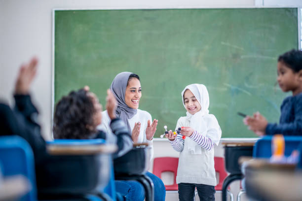 istock Muslim girl giving presentation 1067903948