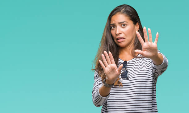 istock Young beautiful arab woman wearing sunglasses over isolated background afraid and terrified with fear expression stop gesture with hands, shouting in shock. Panic concept. 1067904254