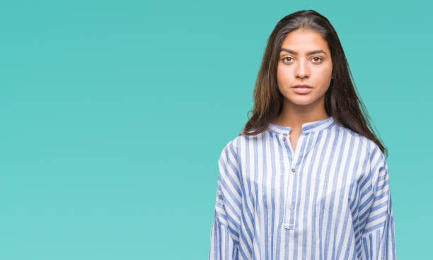 istock Young beautiful arab woman over isolated background with serious expression on face. Simple and natural looking at the camera. 1067904390