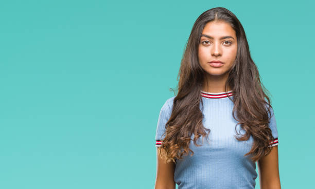 istock Young beautiful arab woman over isolated background with serious expression on face. Simple and natural looking at the camera. 1067904540