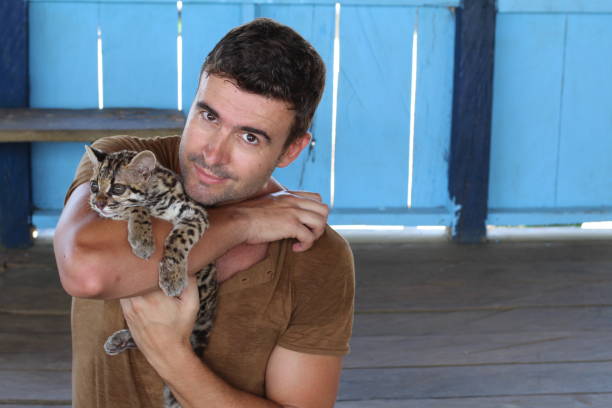 istock Tender human holding baby wild feline 1067907258
