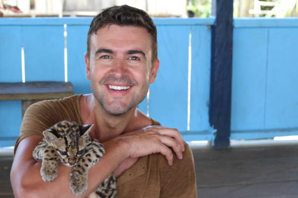 istock Tender man holding baby wild feline 1067907272