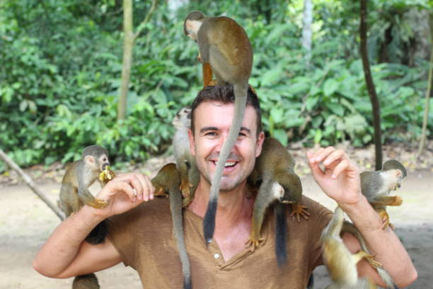 istock Handsome man with titi monkey's group 1067907284