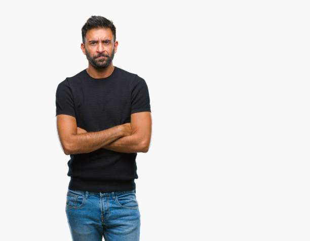 istock Adult hispanic man over isolated background skeptic and nervous, disapproving expression on face with crossed arms. Negative person. 1067908410
