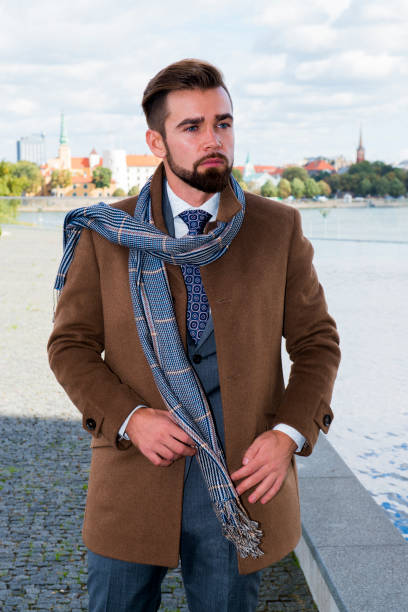 istock The man with a beard in a coat poses 1067908668