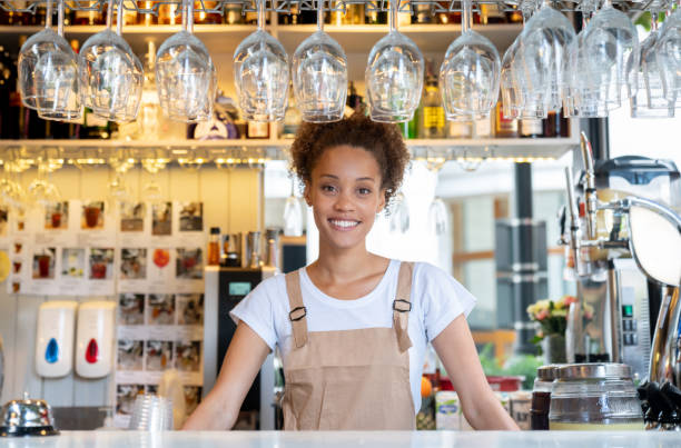 istock Happy woman working at a restaurant behind the counter 1067910440